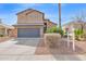 Two-story home featuring a two car garage and desert landscaping in front at 13641 W Solano Dr, Litchfield Park, AZ 85340