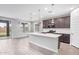 Beautiful modern kitchen with stainless appliances, oversized island, and tiled backsplash at 14433 W Via Del Oro Dr, Surprise, AZ 85379