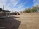 Generous backyard space with covered patio and block fencing, ideal for outdoor activities at 1511 N Kadota Ave, Casa Grande, AZ 85122