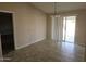 Bright dining area features tile flooring and sliding glass door leading to backyard at 1511 N Kadota Ave, Casa Grande, AZ 85122