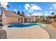 This backyard features a beautiful pool, outdoor seating, and well-manicured landscaping at 15764 W Shiloh Ave, Goodyear, AZ 85338