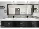 This bathroom offers dual sinks, modern dark wood cabinets, and a bright mirror at 15764 W Shiloh Ave, Goodyear, AZ 85338