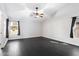 Serene bedroom with large windows and hardwood floors at 15764 W Shiloh Ave, Goodyear, AZ 85338