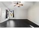 This bedroom offers hardwood floors and bright natural light from the room's two windows at 15764 W Shiloh Ave, Goodyear, AZ 85338