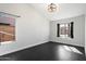 This bedroom offers hardwood floors, and bright natural light from the room's two windows at 15764 W Shiloh Ave, Goodyear, AZ 85338