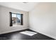 This bedroom features hardwood floors, bright natural light from its single window at 15764 W Shiloh Ave, Goodyear, AZ 85338