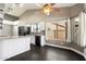 Open-concept kitchen features granite countertops, white cabinetry, and modern appliances for stylish functionality at 15764 W Shiloh Ave, Goodyear, AZ 85338