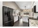 Modern kitchen featuring stainless steel appliances, granite countertops, and ample cabinet space for storage at 15764 W Shiloh Ave, Goodyear, AZ 85338