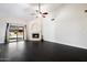 Light-filled living room boasts fireplace, ceiling fan, and sliding doors that offer an abundance of natural light at 15764 W Shiloh Ave, Goodyear, AZ 85338