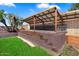 Outdoor patio with a sturdy roof, perfect for relaxation and activities in any weather at 15764 W Shiloh Ave, Goodyear, AZ 85338