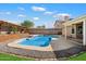 Inviting backyard pool with a modern deck, perfect for outdoor relaxation and entertainment under a bright sky at 15764 W Shiloh Ave, Goodyear, AZ 85338