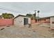 Spacious backyard featuring a detached outbuilding and covered parking area, enclosed by a block wall at 1632 E 3Rd Ave, Mesa, AZ 85204