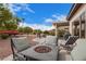 Inviting backyard with a fire pit, comfortable seating, and views of the beautifully landscaped yard at 16533 W Blackhawk Ct, Surprise, AZ 85374