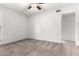 A bright bedroom showcasing neutral carpet, ceiling fan, and ensuite bathroom access at 16631 N 36Th Ave, Phoenix, AZ 85053