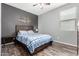 Comfortable bedroom with a ceiling fan, a gray accent wall, and wood look flooring at 17028 W Cocopah St, Goodyear, AZ 85338