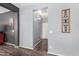 Neutral-toned hallway with modern lighting and convenient access to other areas of the home at 17028 W Cocopah St, Goodyear, AZ 85338