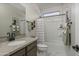 Bathroom with a single sink, stone countertops, and a shower-tub combo at 17050 W Seldon Ln, Waddell, AZ 85355