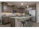 Modern kitchen featuring granite countertops, a kitchen island, and stainless steel appliances at 17050 W Seldon Ln, Waddell, AZ 85355