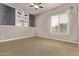 Bedroom with window providing natural light, neutral-toned walls and carpet flooring at 17359 W Grant St, Goodyear, AZ 85338