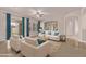 Bright living room with cream colored sofas, blue accents, ceiling fan, and elegant decor at 17359 W Grant St, Goodyear, AZ 85338