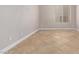 Empty room with tile flooring, providing natural light, and neutral-toned walls at 17359 W Grant St, Goodyear, AZ 85338