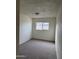 Cozy bedroom featuring plush carpeting and a window for natural light at 1853 W Burgess Ln, Phoenix, AZ 85041