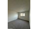 Well-lit bedroom with soft carpeting, and white walls at 1853 W Burgess Ln, Phoenix, AZ 85041