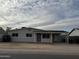 Charming single-story home with a covered parking and a well-maintained front yard at 1853 W Burgess Ln, Phoenix, AZ 85041