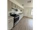 Well-lit kitchen featuring ample cabinetry, modern appliances, and durable countertop at 1853 W Burgess Ln, Phoenix, AZ 85041