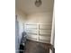 Utility closet with shelves, water heater, and room for storage solutions at 1853 W Burgess Ln, Phoenix, AZ 85041