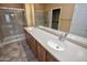 Bathroom with a double sink vanity, glass enclosed shower, and tile flooring at 20156 N 269Th Ln, Buckeye, AZ 85396