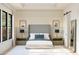 This contemporary bedroom features large black windows, soft lighting, and stylish bedside tables at 20334 W Roma Ave, Buckeye, AZ 85396