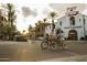 Bicyclists pass storefronts with an inviting streetscape, offering a vibrant community setting at 20334 W Roma Ave, Buckeye, AZ 85396