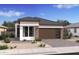Charming single-story home with stone accents, desert landscaping and a two-car garage at 20334 W Roma Ave, Buckeye, AZ 85396