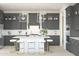 Modern kitchen with gray cabinets, white countertops, stainless steel appliances, and stylish pendant lighting at 20334 W Roma Ave, Buckeye, AZ 85396
