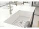 Farmhouse kitchen sink with white countertop and stainless steel faucet at 20334 W Roma Ave, Buckeye, AZ 85396