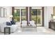 Cozy living room with modern furniture, large windows, and access to the outdoor patio at 20334 W Roma Ave, Buckeye, AZ 85396