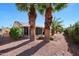 The beautiful backyard has a large, covered patio and mature palm trees at 20462 N Ridgewood Ln, Surprise, AZ 85374