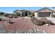 A well maintained single-story home featuring desert landscaping and an attached two car garage at 20462 N Ridgewood Ln, Surprise, AZ 85374