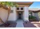 Inviting front entryway with a secure screen door, covered porch and desert landscaping at 20462 N Ridgewood Ln, Surprise, AZ 85374