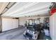 Organized garage with built-in storage cabinets, and a golf cart at 20462 N Ridgewood Ln, Surprise, AZ 85374
