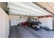 Organized garage with built-in storage cabinets, and a golf cart at 20462 N Ridgewood Ln, Surprise, AZ 85374