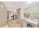Utility area with laundry machines, storage, and access to additional appliances at 20462 N Ridgewood Ln, Surprise, AZ 85374