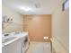 Bright laundry room with tile floors, shelving, appliances, and a bench at 20462 N Ridgewood Ln, Surprise, AZ 85374