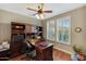 Comfortable home office featuring hardwood floors, built-in shelving, and natural light at 20462 N Ridgewood Ln, Surprise, AZ 85374