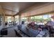 Spacious covered patio with dining and seating areas, perfect for outdoor entertainment at 20462 N Ridgewood Ln, Surprise, AZ 85374