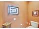 Small toilet room with a decorative storage cabinet and framed nature prints at 20462 N Ridgewood Ln, Surprise, AZ 85374