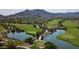 Stunning aerial view of the golf course and surrounding community with a beautiful lake at 2067 N Marketside Ave, Buckeye, AZ 85396