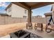 Spacious backyard patio with fire pit and chairs, perfect for outdoor gatherings at 2067 N Marketside Ave, Buckeye, AZ 85396