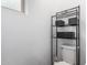 Bathroom featuring a toilet next to a three-tiered shelf with decorative baskets at 2067 N Marketside Ave, Buckeye, AZ 85396